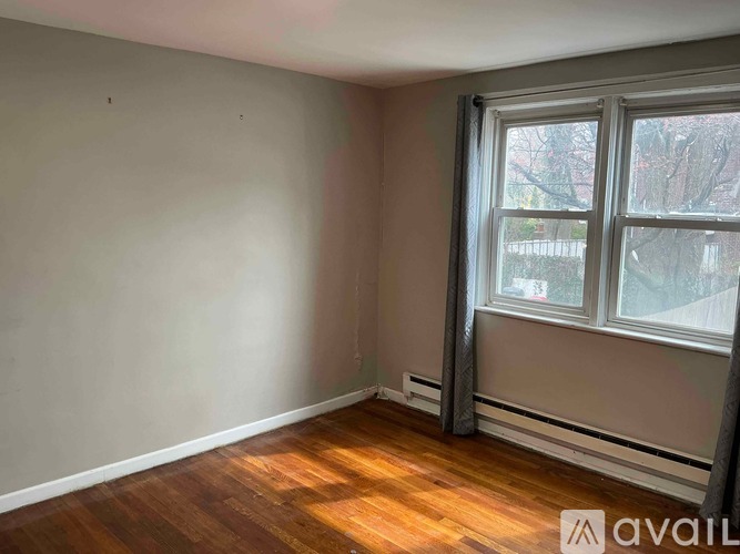 A room with wooden floors and a large window.