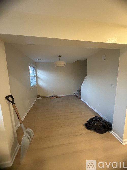 A room with a shovel leaning against the wall.