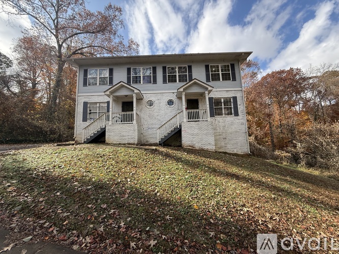 A two-story house with a balcony on the second floor.