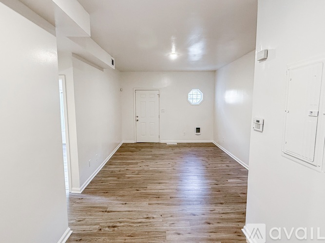 A room with wooden floors and white walls.
