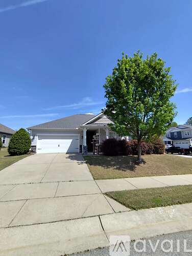 A house with a tree in front of it.