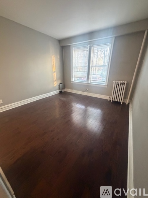 A room with wooden floors and a window.