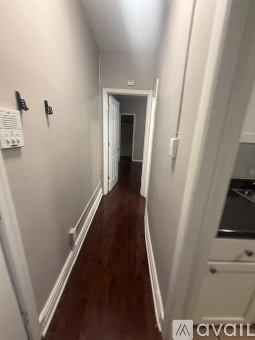 A long hallway with a door at the end.