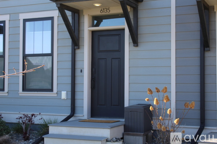 A house numbered 6135 has a dark blue front door.