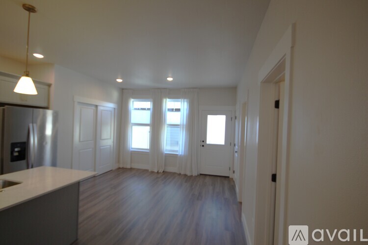 A kitchen with a refrigerator, sink, and cabinets is available for rent.
