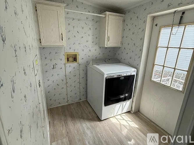 A small kitchen with a white cabinet and a white dishwasher.