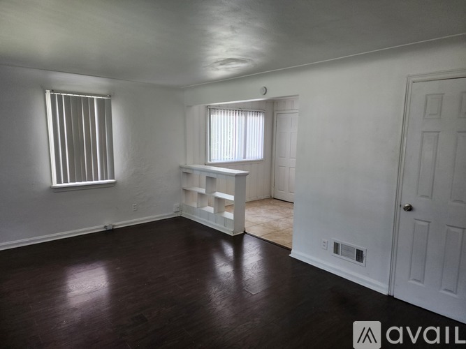 A room with wooden floors and white walls.