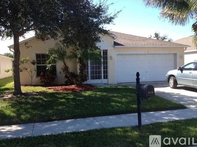 A house with a white garage door and a black mailbox.