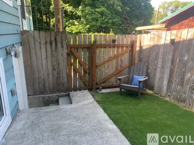 A backyard with a wooden fence and gate.