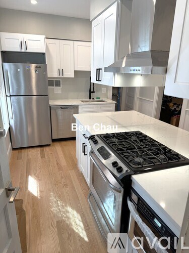 A kitchen with a stove top oven and a refrigerator.