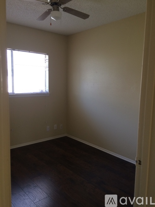 A room with a ceiling fan and a window.