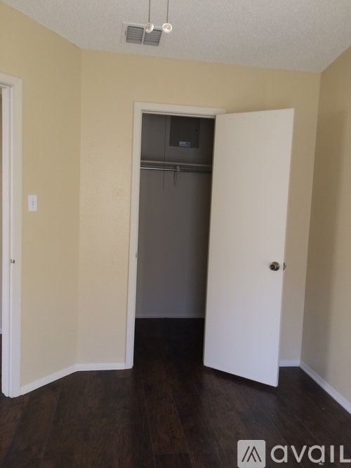 A room with a door and a wall socket.