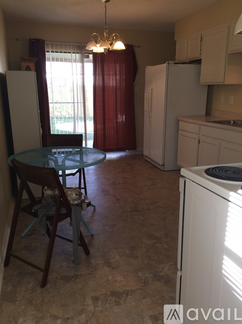 A kitchen with a table and chairs in it.