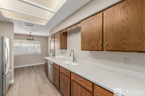 A kitchen with wooden cabinets and a white countertop.
