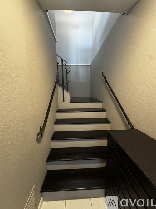 A staircase with black and white steps.