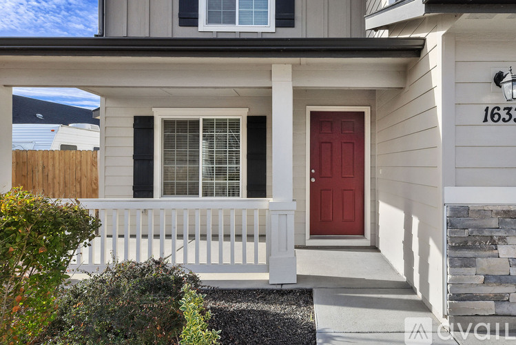A house with a red door and a white porch.