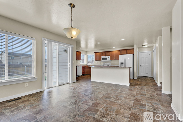 A kitchen with tile flooring and a large island.