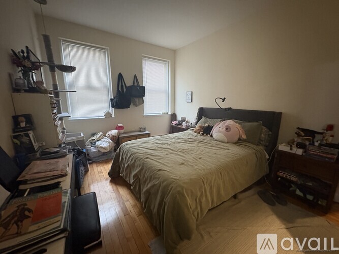 A bedroom with a bed, a chair, and a bookshelf.
