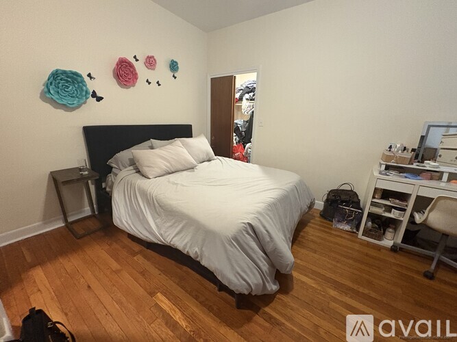 A bedroom with a bed, desk, and chair.