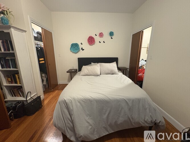 A bedroom with a large bed and a bookshelf.