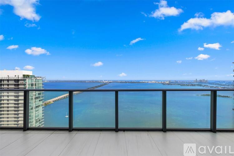 A balcony with a view of a bridge and buildings.