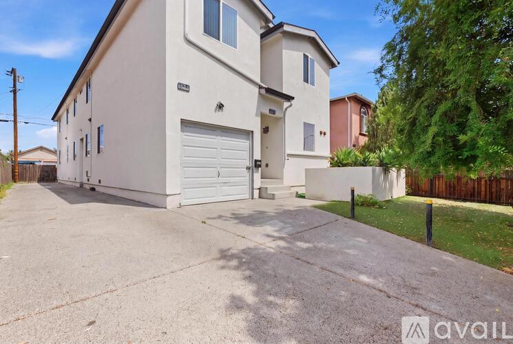 A two-story house with a garage is available for rent.