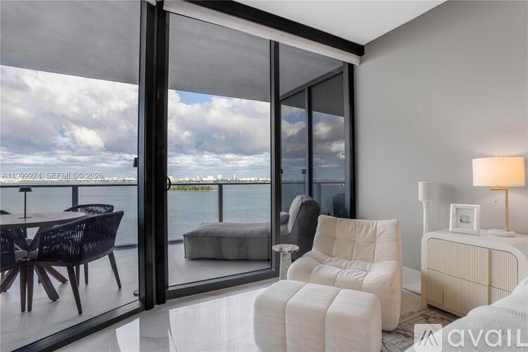 A modern living room with a view of the water.