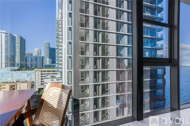 A modern building with a view of the cityscape and water.