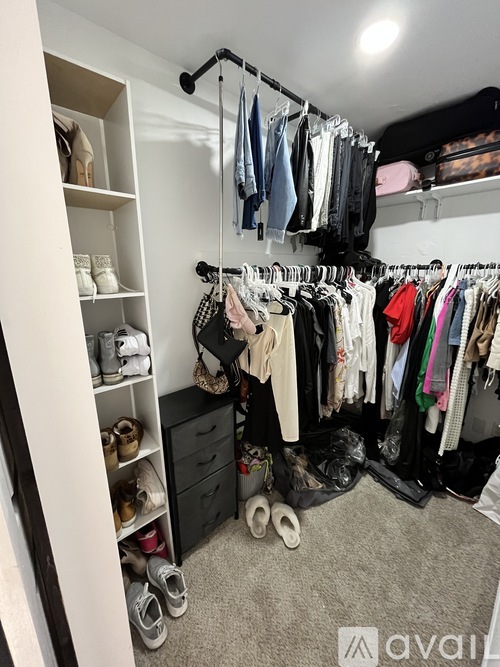 A well-organized closet with clothes and shoes neatly arranged.
