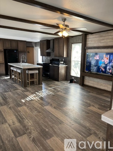 A living room with wooden floors and furniture.