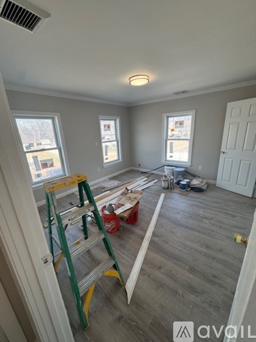 A room with a ladder and some construction materials.