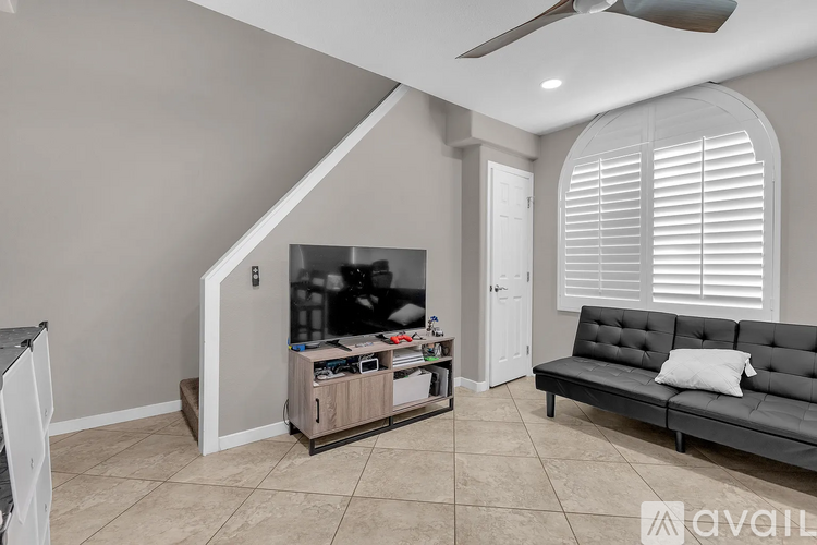 A living room with a grey sofa and a television.