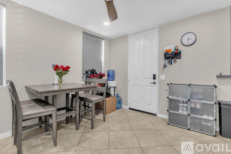 A dining room with a table and chairs.