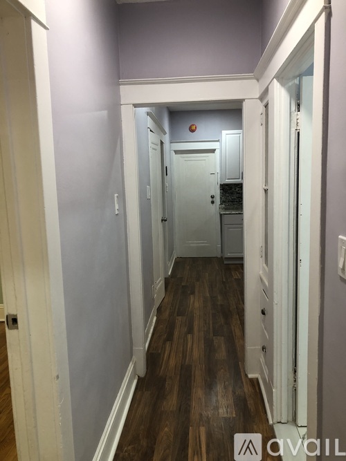 A hallway with a door at the end.