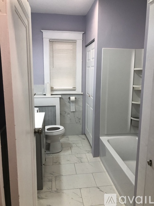 A bathroom with a toilet, sink, and bathtub.