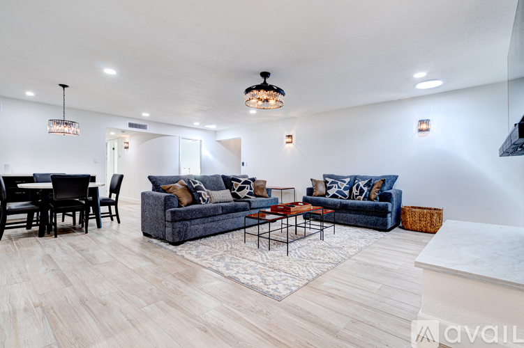 A living room with a grey couch and a coffee table.
