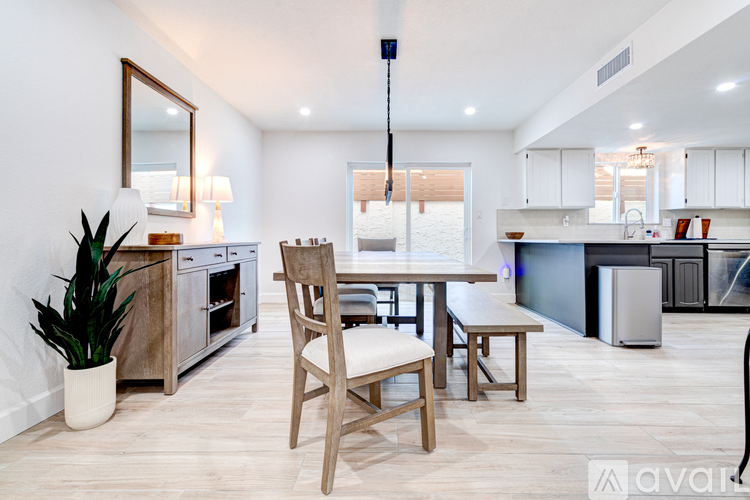 A modern kitchen with a dining table and chairs.