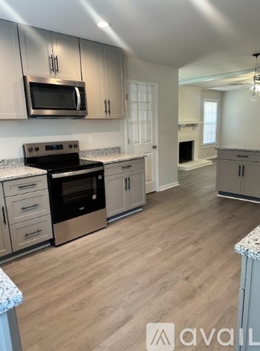 A kitchen with a stove top oven and microwave.