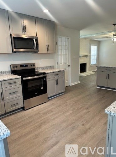 A kitchen with a stove top oven and microwave.