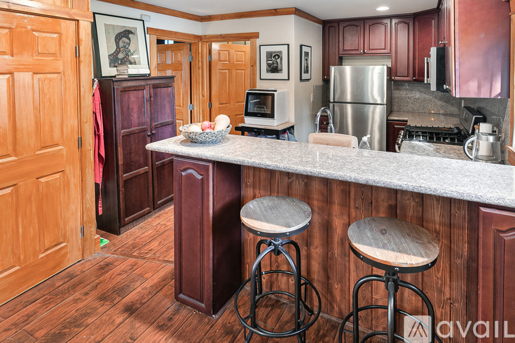 A kitchen with wooden cabinets and a white countertop.