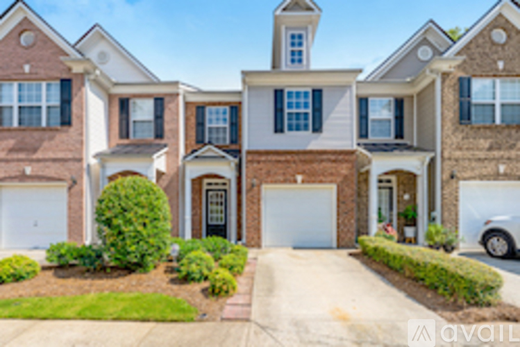 A large house with a white garage door is for sale.