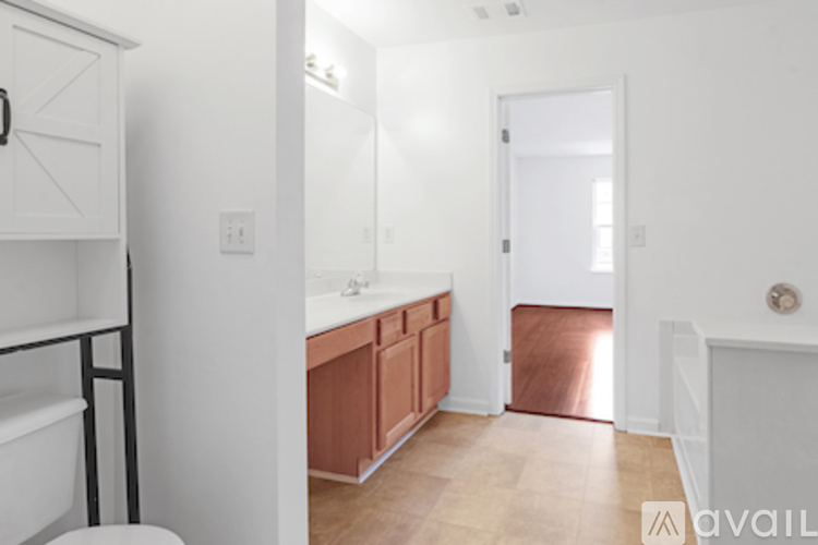 A bathroom with a toilet, sink, and bathtub.