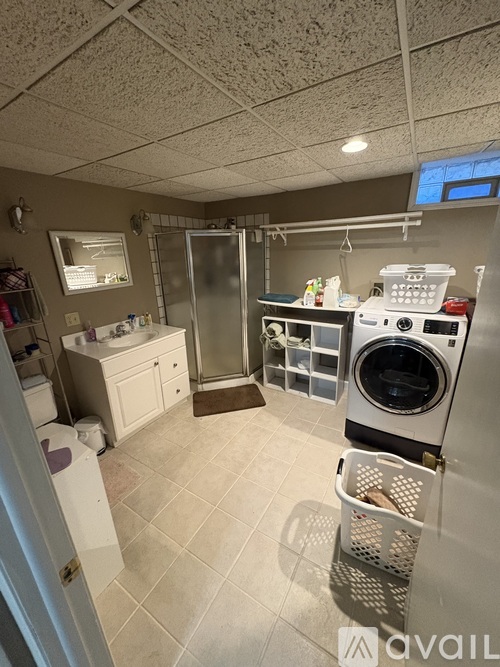 A small laundry room with a washer and dryer.