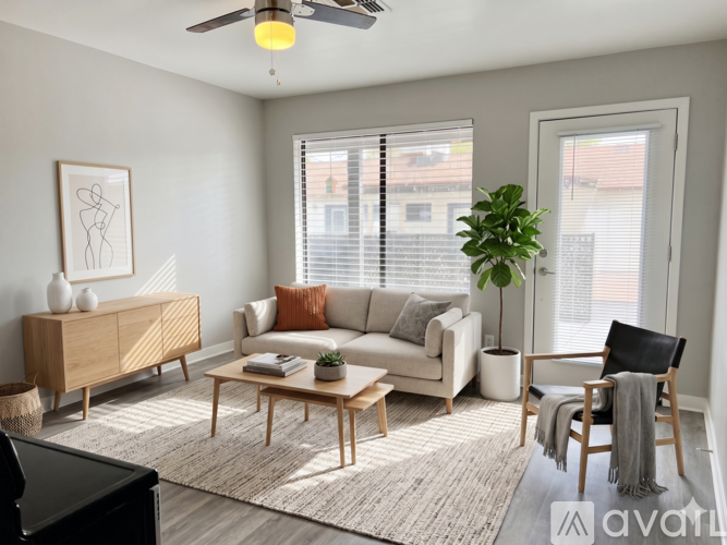 A living room with a wooden floor and furniture.