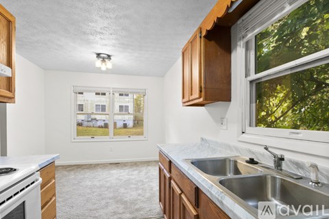 A kitchen with a stove top oven and a sink.