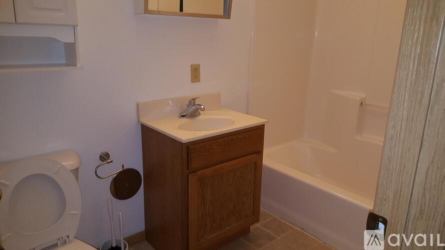 A white toilet sits next to a sink in a bathroom.