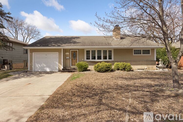 A house with a white garage door and a brown roof.