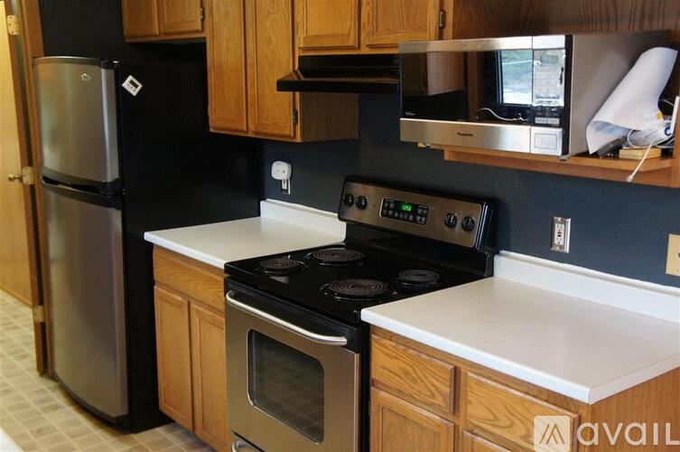 A kitchen with a stove top oven and microwave.