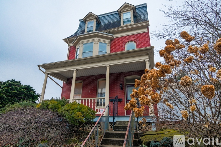 A red house with a blue roof and white trim.