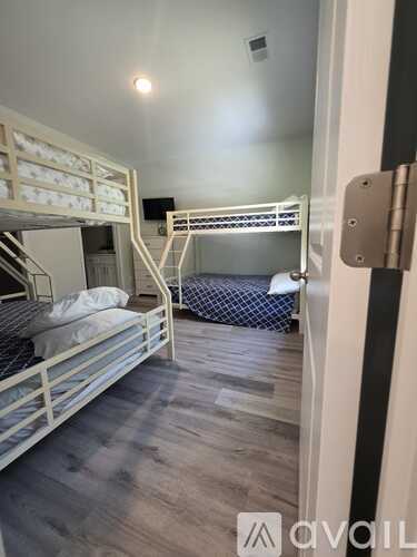 A room with bunk beds and a door with a lock.